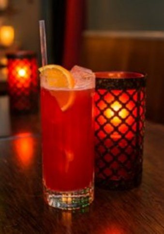 Orange cocktail candle lit